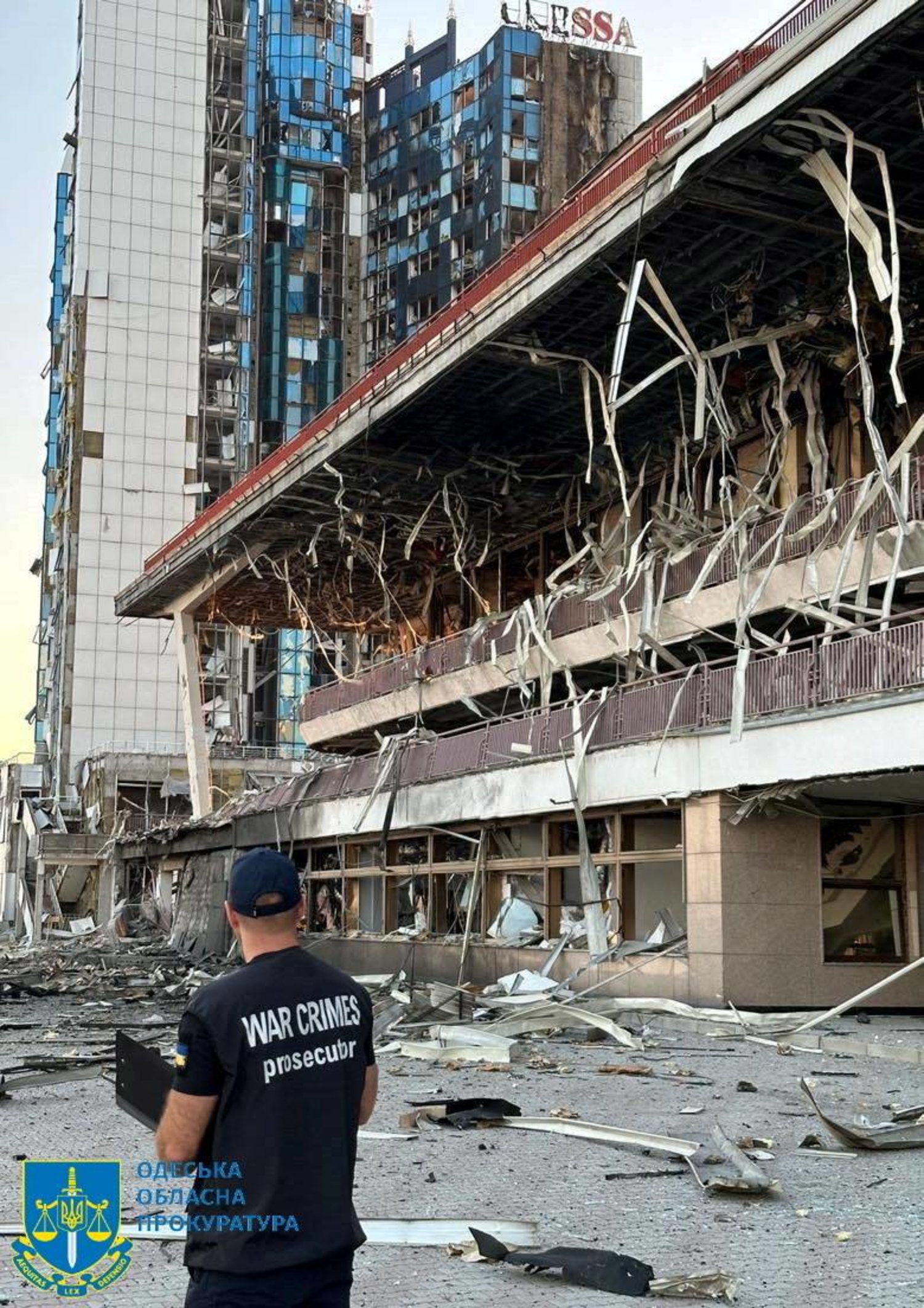 مسؤول يعاين أمس الدمار في مبنى بأوديسا استهدفتة ضربة روسية (رويترز) 