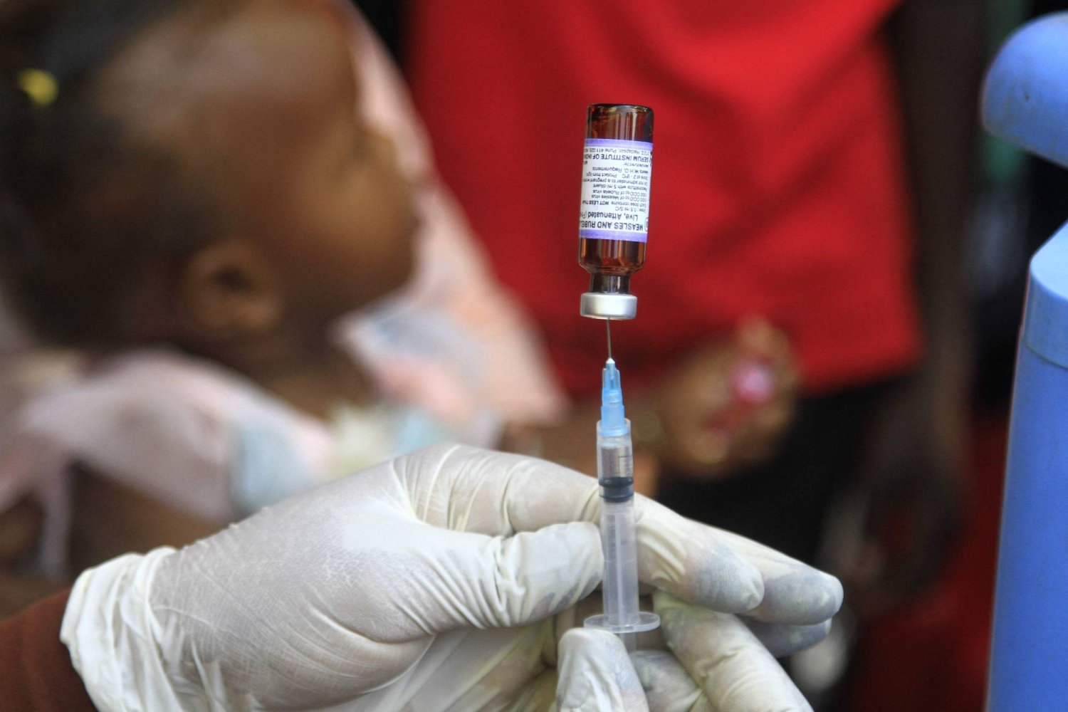 ممرضة سودانية تقوم بإعداد جرعة لقاح خلال حملة التطعيم ضد الحصبة (أ.ف.ب)