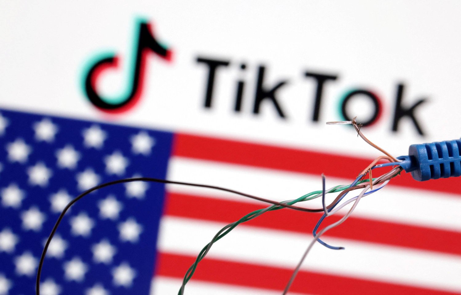 صورة للعلم الأميركي وشعار «تيك توك» (رويترز)