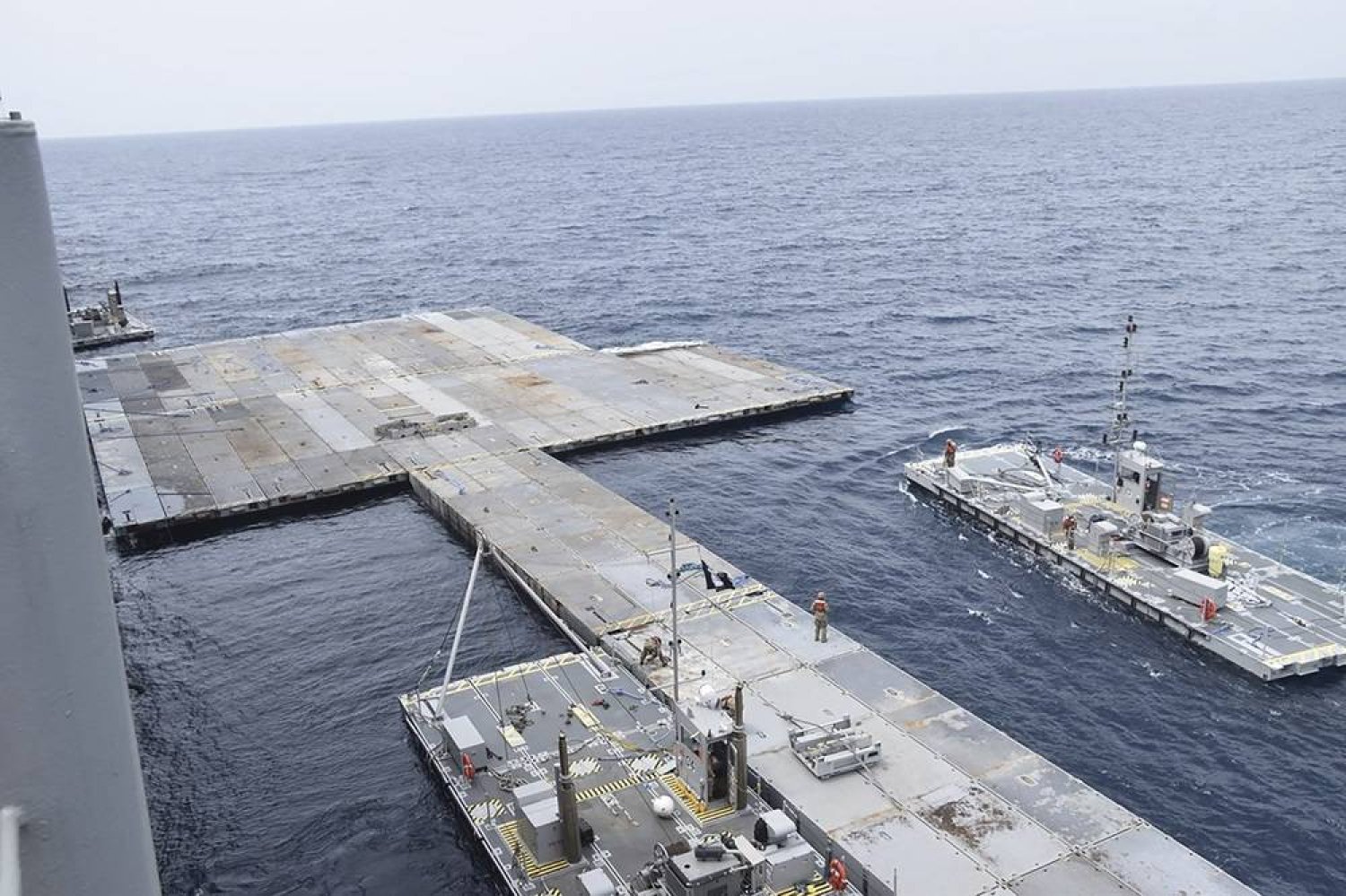 This undated photo released early Tuesday, April 30, 2024, by the US military's Central Command shows construction off a floating pier in the Mediterranean Sea off the Gaza Strip. (US military's Central Command via AP) 