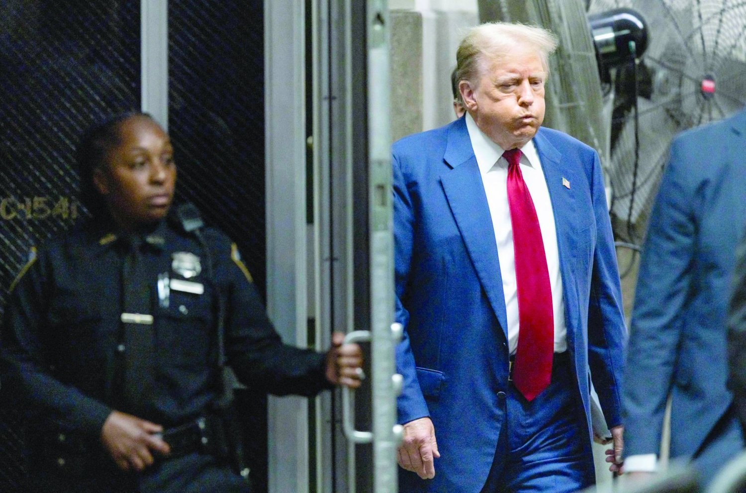 Former US President Donald Trump walks back to the courtroom after a break in his trial for allegedly covering up hush money payments linked to extramarital affairs, at Manhattan Criminal Court in New York City, on April 30, 2024. (Photo by JUSTIN LANE / POOL / AFP)