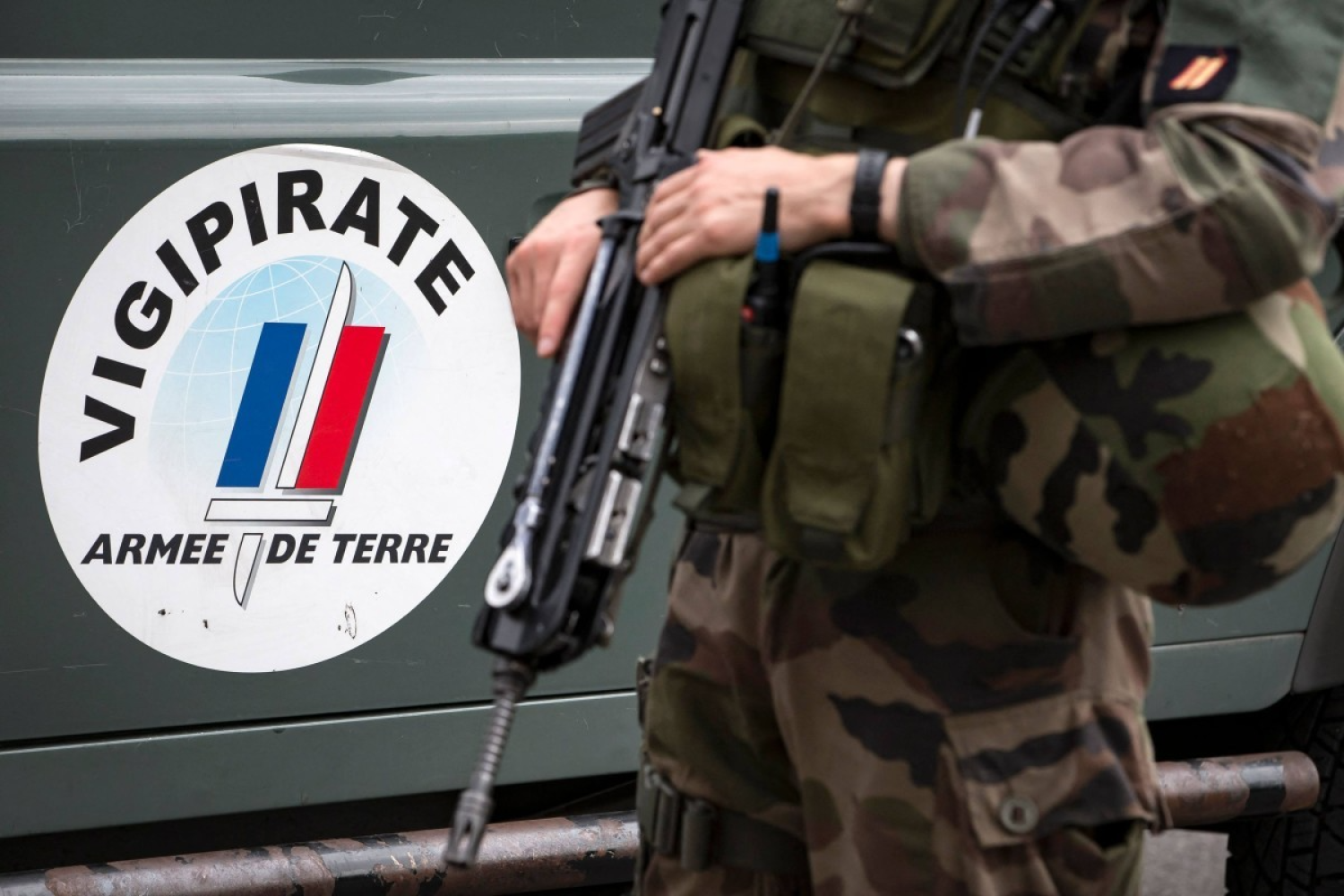 A French soldier next to the logo for France’s anti-terror plan “Vigipirate” (AFP)