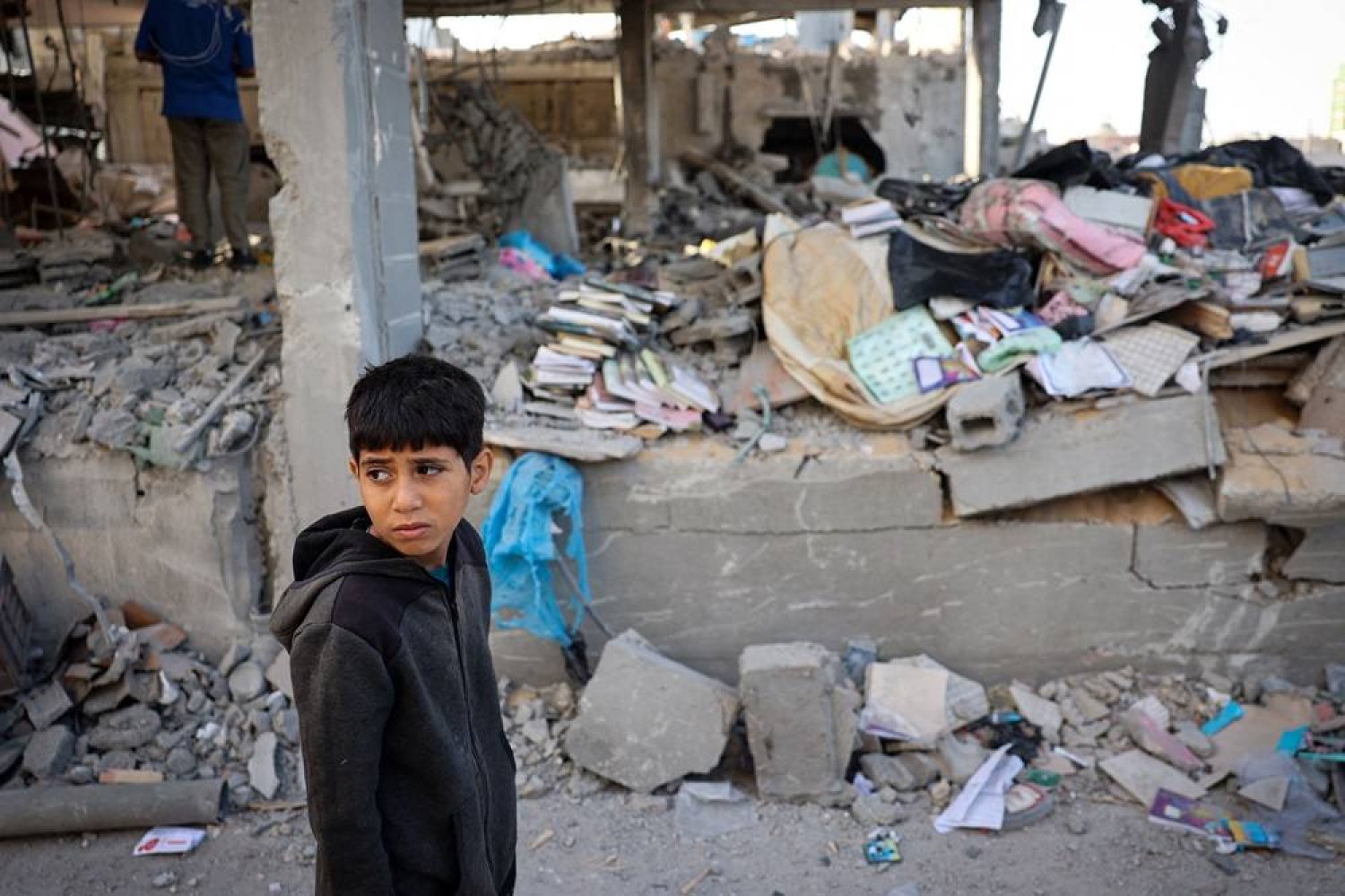 A Palestinian child stands in front of a building destroyed by Israeli bombing in Rafah in the southern Gaza Strip on May 3, 2024, amid the ongoing conflict between Israel and the Hamas movement. (AFP) 
