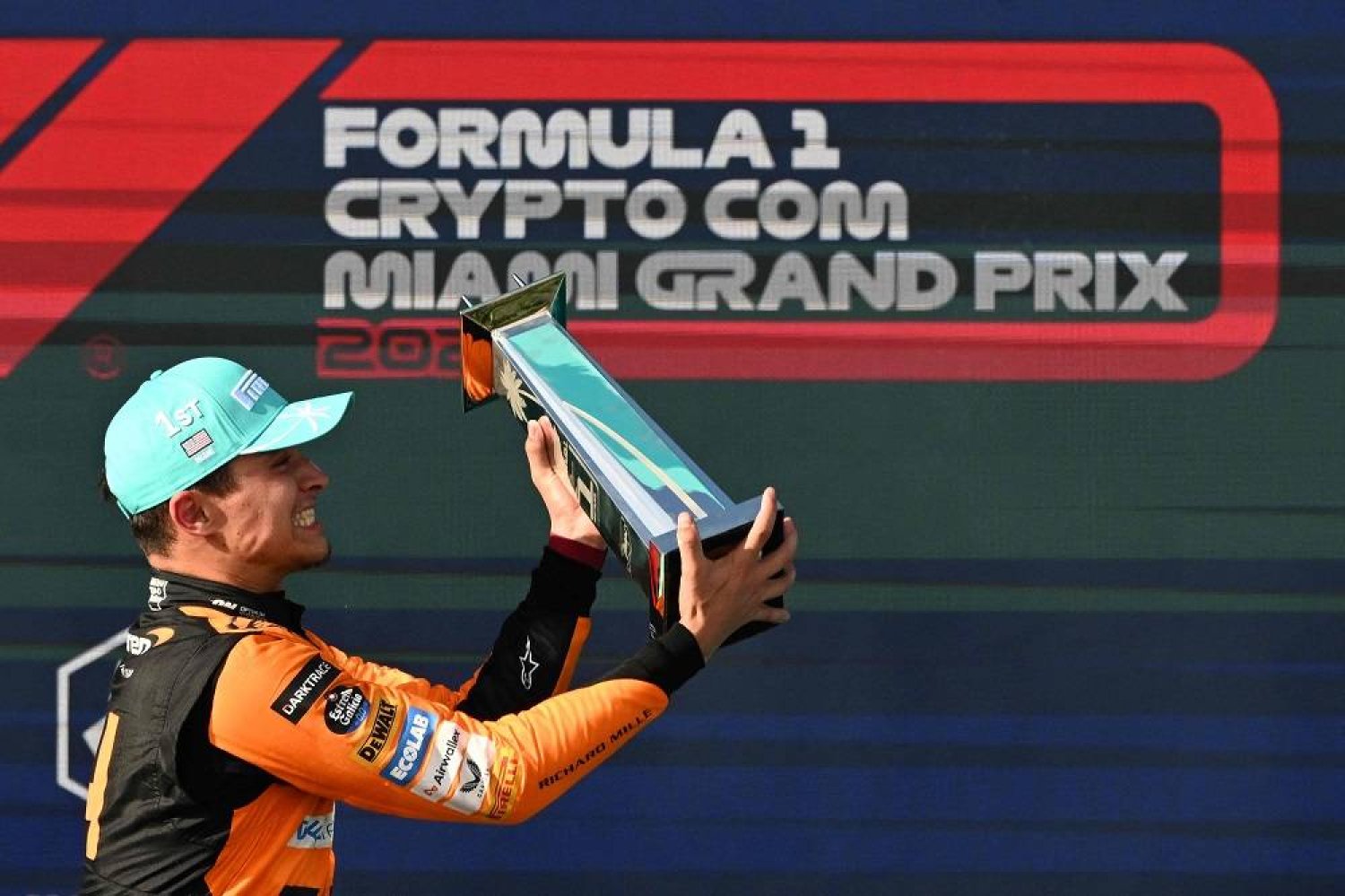 McLaren's British driver Lando Norris celebrates with his trophy on the podium after winning the 2024 Miami Formula One Grand Prix at Miami International Autodrome in Miami Gardens, Florida, on May 5, 2024. (AFP)