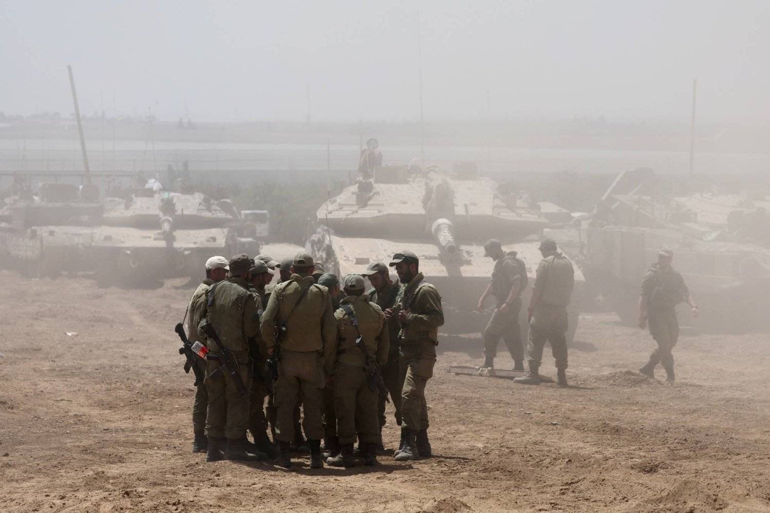 Israeli soldiers gather on the border with the Gaza Strip (AP)
