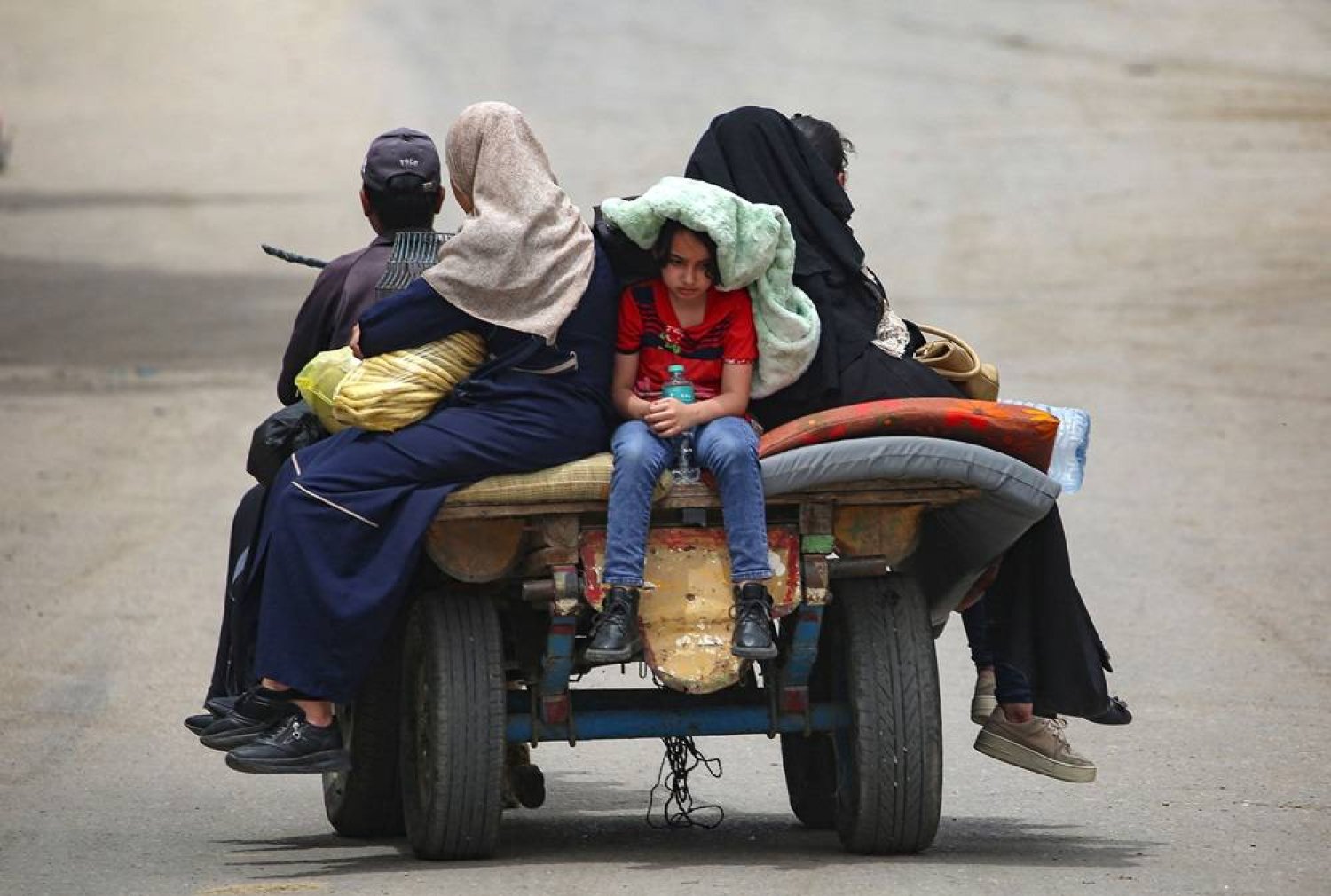 Palestinians sit on an animal pulled cart as they move to safer areas in Rafah, in the southern Gaza Strip, on May 10, 2024, amid the ongoing conflict between Israel and Hamas. (AFP)