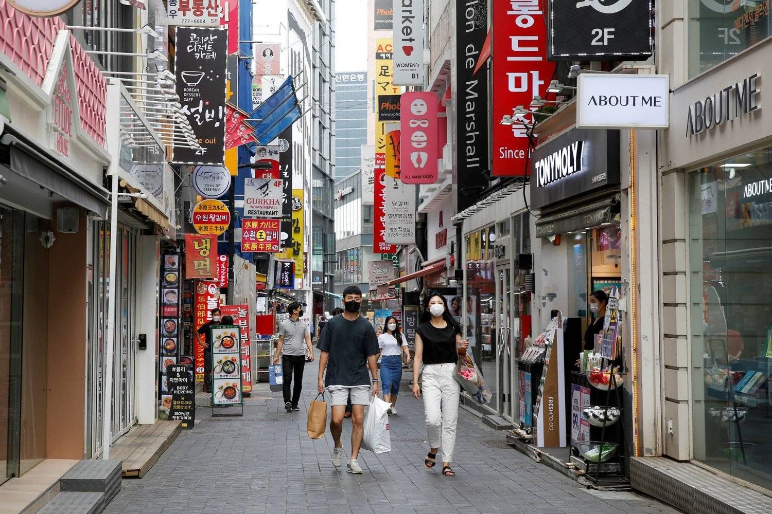 متسوقون في أحد الشوارع التجارية بالعاصمة الكورية الجنوبية سيول (رويترز)