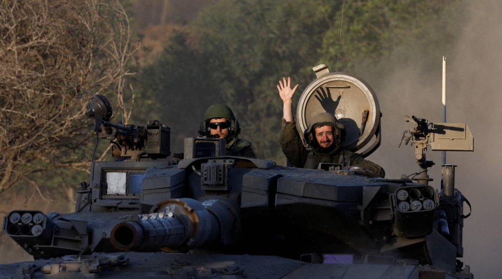 جنود إسرائيليون في دبابة على حدود قطاع غزة (رويترز) 