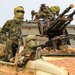 مقاتلون يقودون آليات عسكرية في السودان (أ.ف.ب)