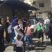 نساء وأطفال أثناء الهروب من الاشتباكات في عين الحلوة في 17 سبتمبر (أ.ب)